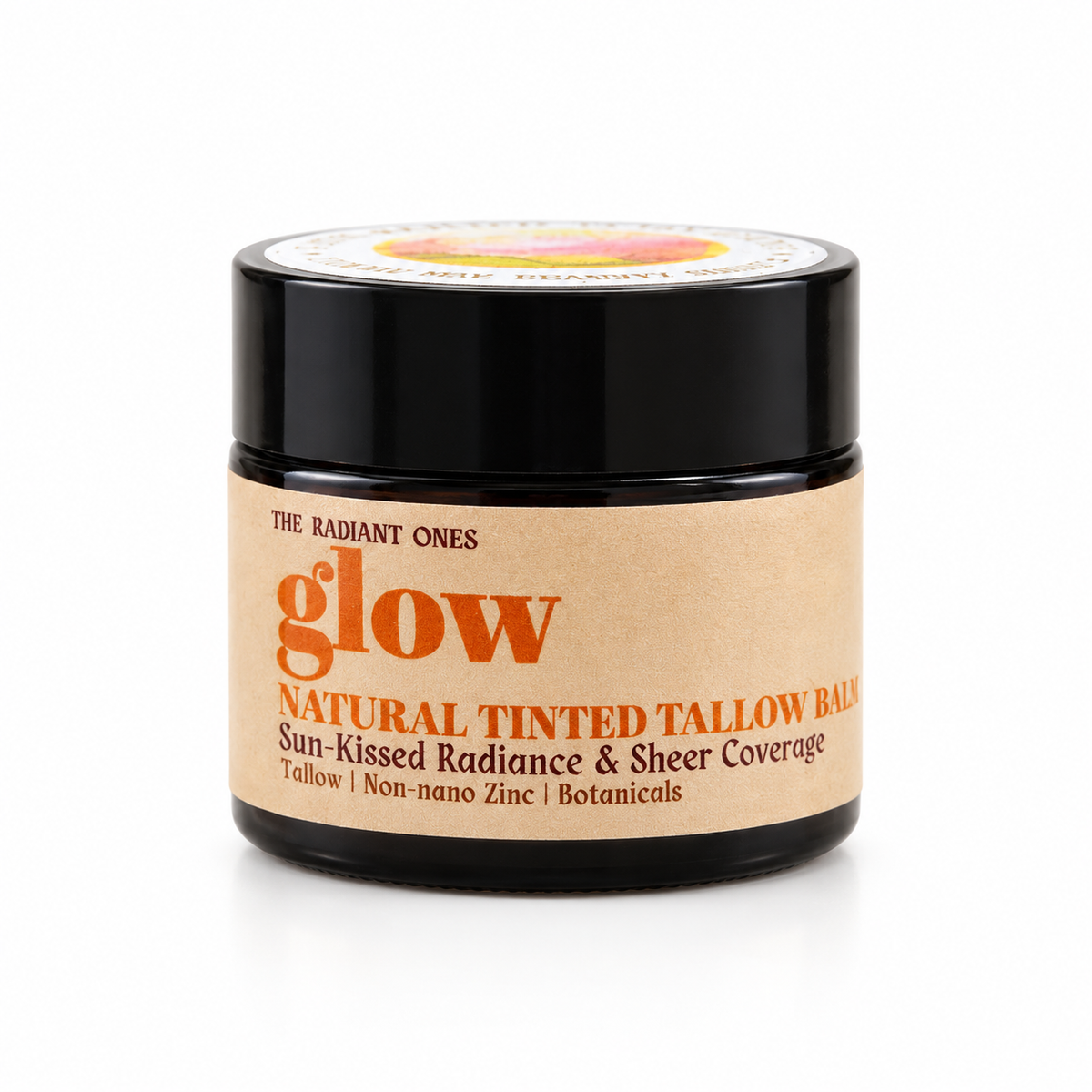 A jar of Glow Natural Tinted Tallow Balm by The Radiant Ones, featuring a black jar with a kraft paper label and orange lettering, set against a plain white background.
